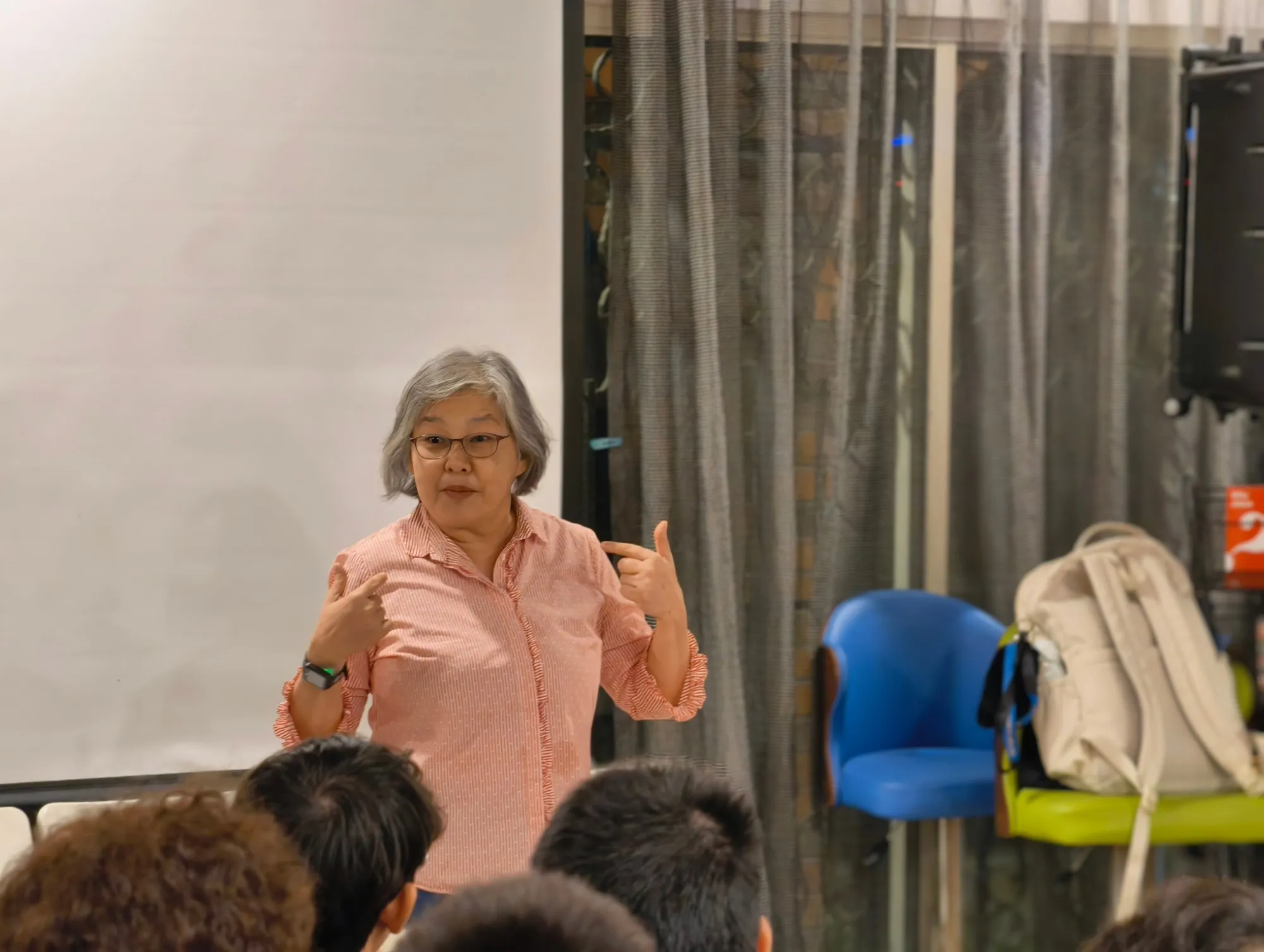 A speaker sharing with a group of students at DU House